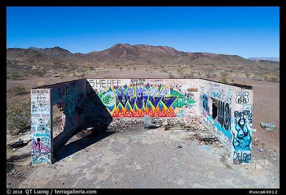 Aerial view of abandonned structure with graffiti and route 66 marker. Mojave Trails National Monument, California, USA