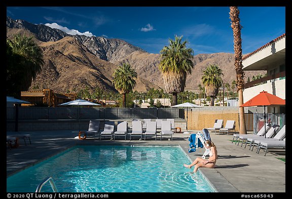 Woman at swimming pool and San Jacinto Mountains, Palm Springs, Palm Springs. California, USA (color)