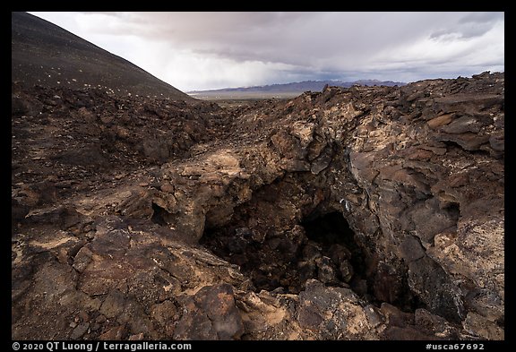 Pisgah Cinder cone and entrance to lava tube cave. Mojave Trails National Monument, California, USA (color)