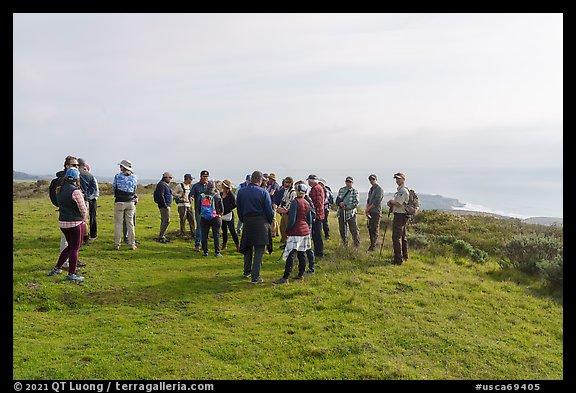 Group on edge of grassy terrace above the Pacific Ocean. Cotoni-Coast Dairies Unit, California Coastal National Monument, California, USA (color)