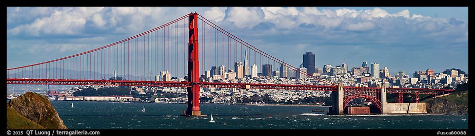 Golden Gate Bridge, and San Francisco city skyline with cloudy sky. San Francisco, California, USA (color)