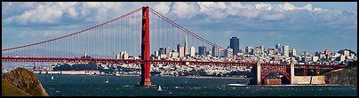 Golden Gate Bridge, and San Francisco city skyline with cloudy sky. San Francisco, California, USA (Panoramic color)