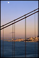 The city seen through the cables of the Golden Gate bridge, sunset. San Francisco, California, USA (color)