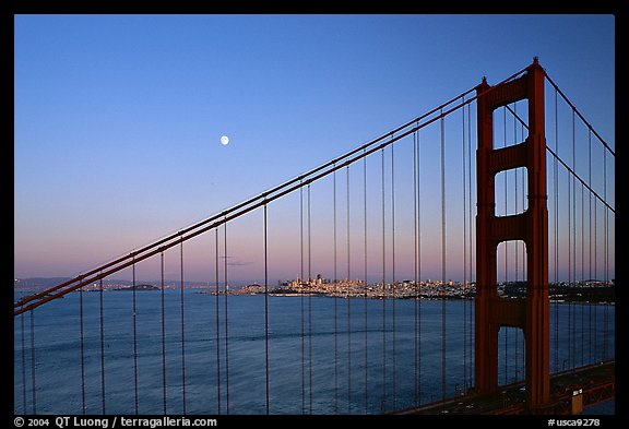 The city seen through the cables of the Golden Gate bridge, sunset. San Francisco, California, USA