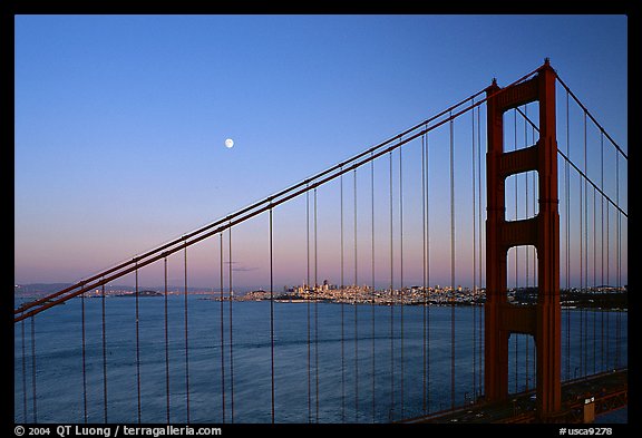 The city seen through the cables of the Golden Gate bridge, sunset. San Francisco, California, USA (color)