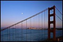 The city seen through the cables of the Golden Gate bridge, sunset. San Francisco, California, USA (color)