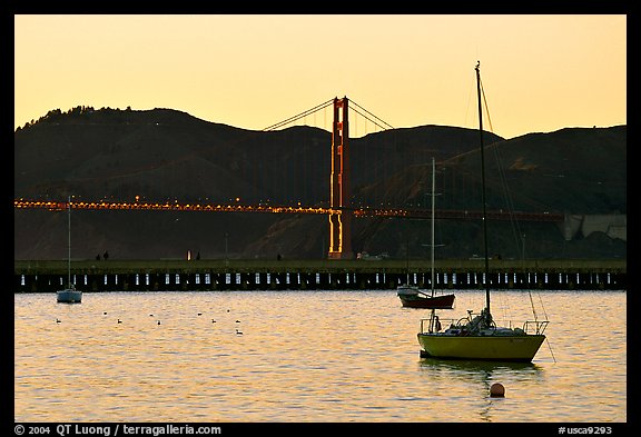 Sailboat in the Marina, with Golden Gate Bridge at sunset in the background. San Francisco, California, USA (color)