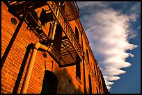 Old brick building and serrated cloud, sunset, Fisherman's Wharf. San Francisco, California, USA
