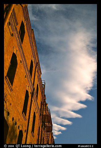 Old brick building and serrated cloud, sunset, Fisherman's Wharf. San Francisco, California, USA