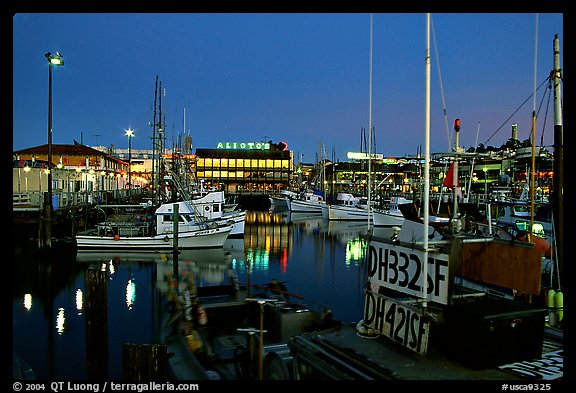 Fishing boat in Fisherman's Wharf, with Alioto's in the background, dusk. San Francisco, California, USA