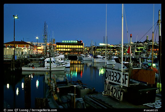 Fishing boat in  Fisherman's Wharf, with Alioto's in the background, dusk. San Francisco, California, USA