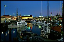 Fishing boat in Fisherman's Wharf, with Alioto's in the background, dusk. San Francisco, California, USA