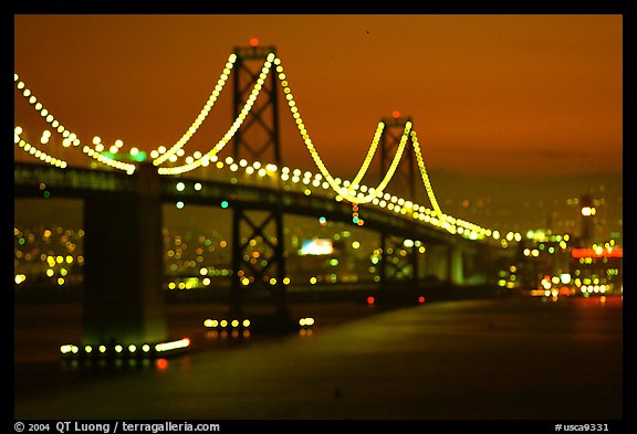 Bay Bridge seen from Treasure Island with defocused lights, sunset. San Francisco, California, USA