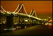 Bay Bridge seen from Treasure Island with defocused lights, sunset. San Francisco, California, USA (color)