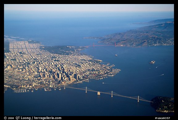 Aerial view of the Bay Bridge, the city, and  the Golden Gate Bridge. San Francisco, California, USA (color)