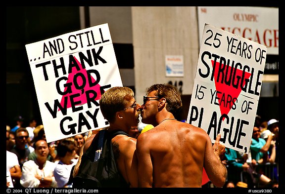 Gay couple with signs during the Gay Parade. San Francisco, California, USA (color)