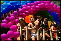 Men with rainbowed ballons on a float during the Gay Parade. San Francisco, California, USA