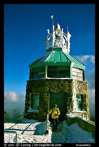 Hiker gets out of the ice-clad summit tower during a cold winter day, Mt Diablo State Park. California, USA (color)