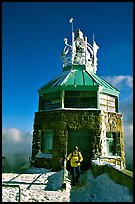 Hiker gets out of the ice-clad summit tower during a cold winter day, Mt Diablo State Park. California, USA ( color)