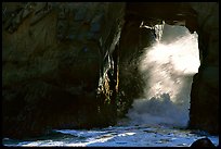 Light and wave through Arch Rock at Pfeiffer Beach. Big Sur, California, USA