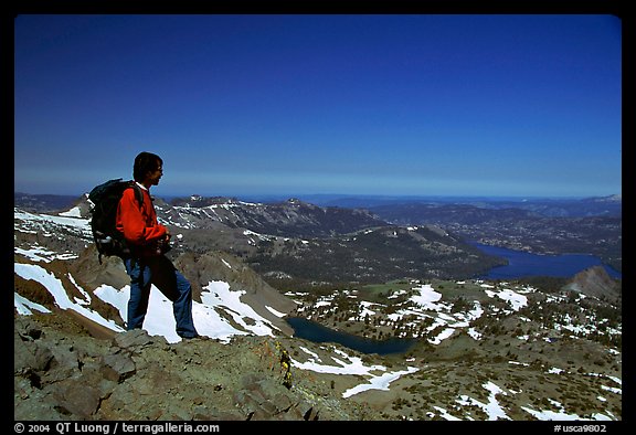 Hiker standing on top of Round Top Peak. Mokelumne Wilderness, Eldorado National Forest, California, USA