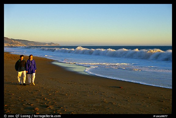 Couple strolling on the beach, late afternoon. Point Reyes National Seashore, California, USA