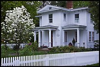 White picket fence and house, Essex. Connecticut, USA