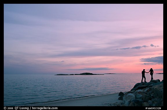 Beach with atlantic sunset and couple, Westbrook. Connecticut, USA