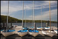 Small sailboasts parked on deck and Mystic River. Mystic, Connecticut, USA