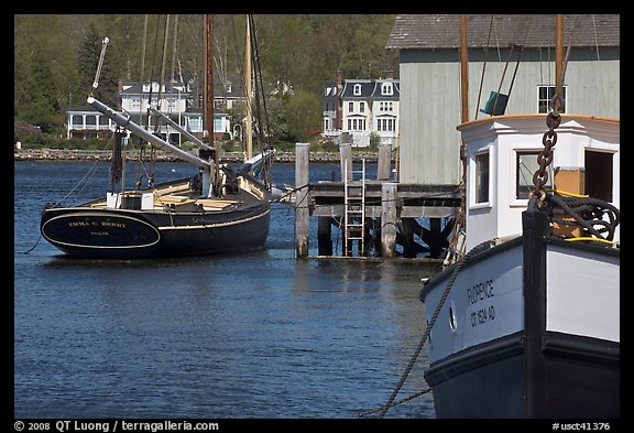 Historic boats, Mystic River, and houses. Mystic, Connecticut, USA