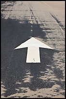 Painted arrow, asphalt, and sand, Cape Cod National Seashore. Cape Cod, Massachussets, USA (color)