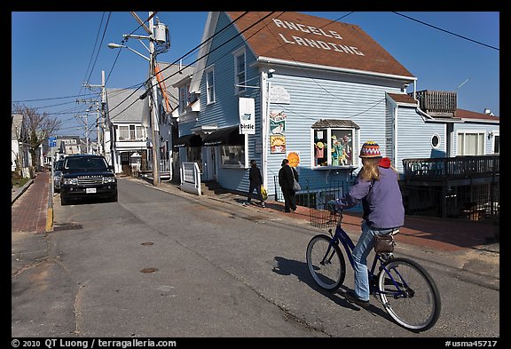 Woman biking on main street, Provincetown. Cape Cod, Massachussets, USA