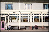 Men sitting in front of candy store, Provincetown. Cape Cod, Massachussets, USA