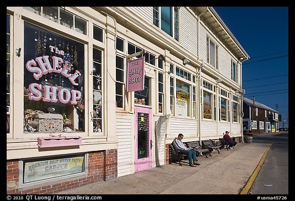 Men sitting on sidewalk benches, Provincetown. Cape Cod, Massachussets, USA