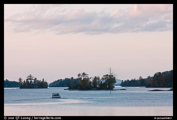 Motorboat and islets at sunset,  Moosehead Lake, Greenville. Maine, USA