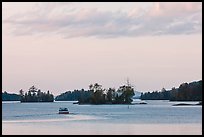 Motorboat and islets at sunset,  Moosehead Lake, Greenville. Maine, USA ( color)