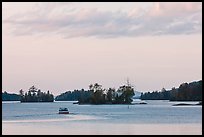 Motorboat and islets at sunset,  Moosehead Lake, Greenville. Maine, USA