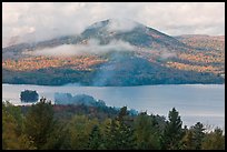 Autumn scenery with lake and clouds lifting up. Maine, USA