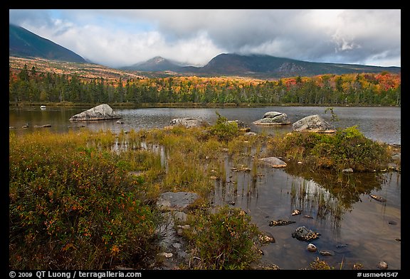 Mountains with fall colors rising above pond. Baxter State Park, Maine, USA