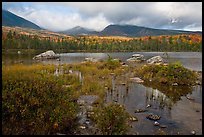 Mountains with fall colors rising above pond. Baxter State Park, Maine, USA (color)