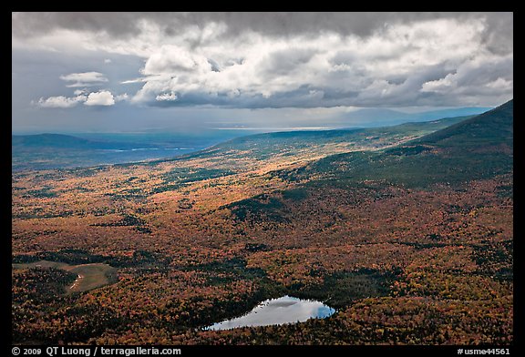 View with storm light and clouds over slopes covered with fall foliage. Baxter State Park, Maine, USA (color)
