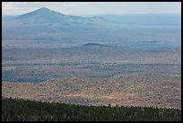 Distant hills rising above forested slopes in fall foliage. Baxter State Park, Maine, USA