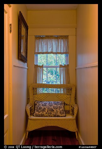 Corridor in inn with chair and window looking out to trees. Maine, USA (color)