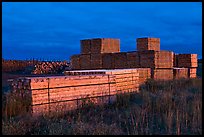 Stacks of finished lumber at dusk,  Ashland. Maine, USA (color)