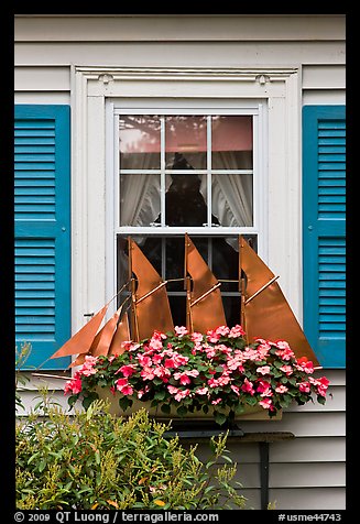 Window with decorative sailboat and flowers. Bar Harbor, Maine, USA (color)