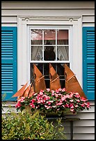 Window with decorative sailboat and flowers. Bar Harbor, Maine, USA