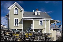 Lobster traps lined in front of house. Stonington, Maine, USA (color)