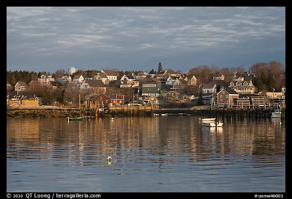 Harber and hillside houses at sunrise. Stonington, Maine, USA