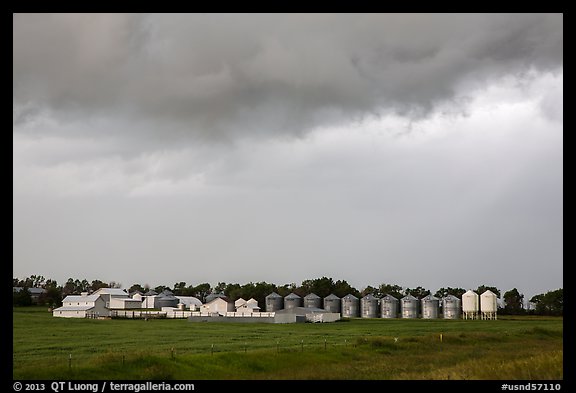 Storm clouds over grain silos. North Dakota, USA (color)