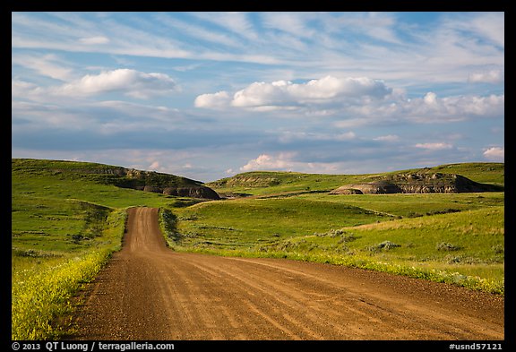 Gravel road, rolling hills and badlands. North Dakota, USA (color)